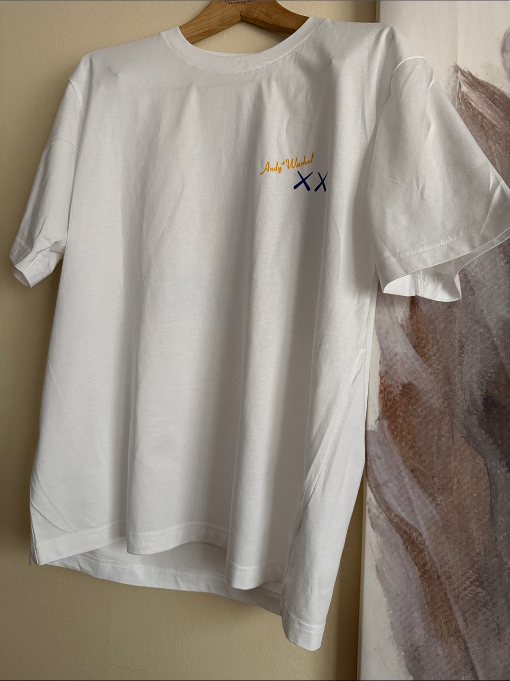 Uniqlo White Short-Sleeve Tee with Yellow Script and Navy XX Logo